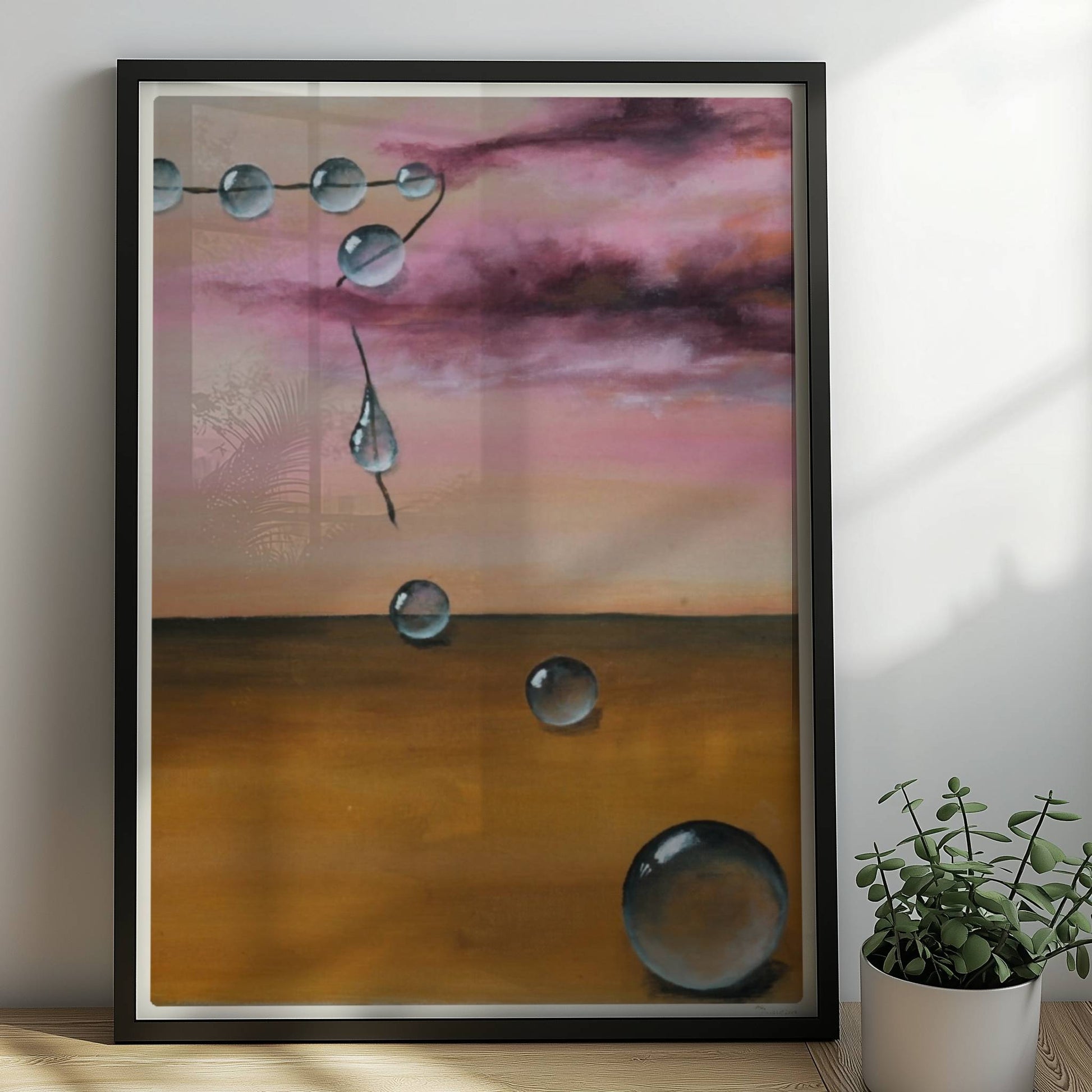 13 schwebende Glastropfen vor rosarotem Himmel über Wüste.. Rahmen schwarz 50x70