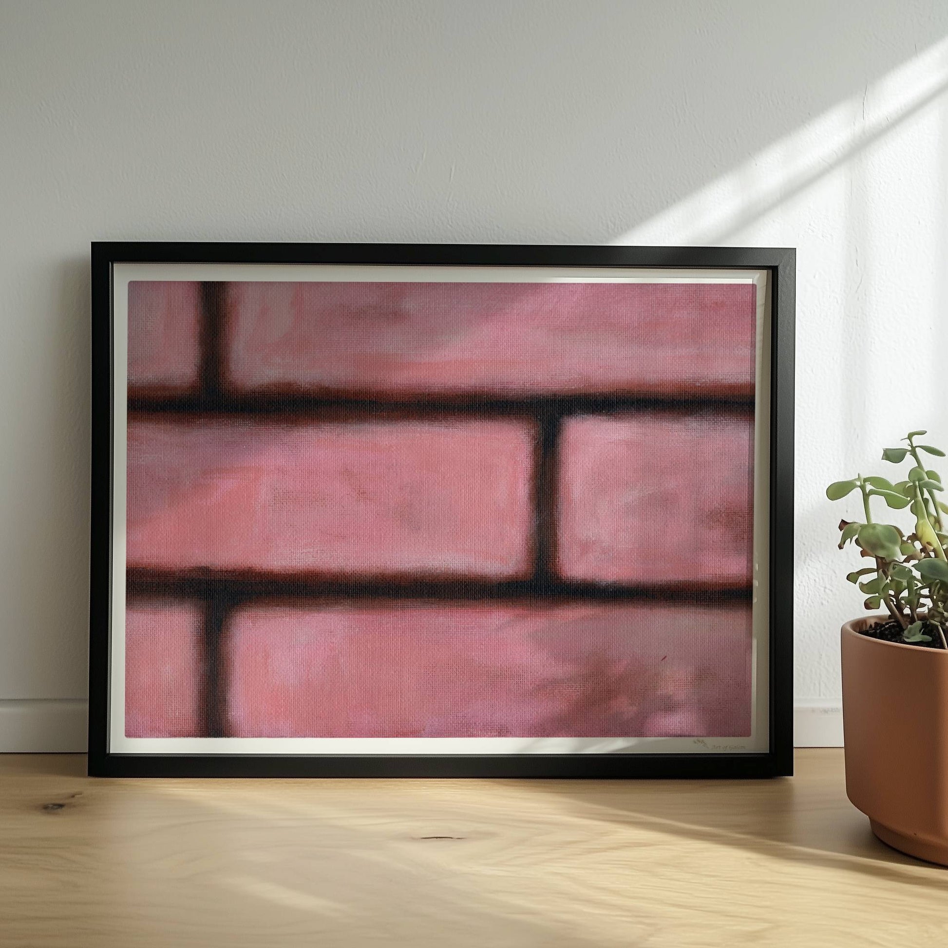 Rosafarbene Ziegelwand mit weichen Kanten und künstlerischem Flair.. Rahmen schwarz 40x30