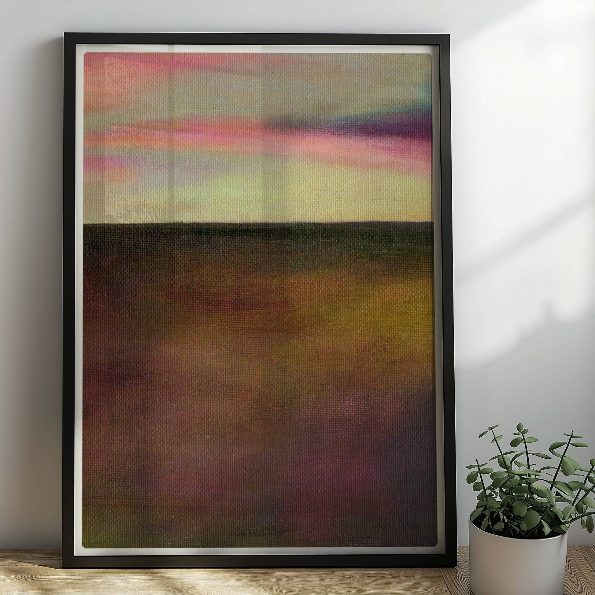 Einzelner goldener Tropfen vor farbigem Wolkenhimmel, surreal.. Rahmen schwarz 50x70
