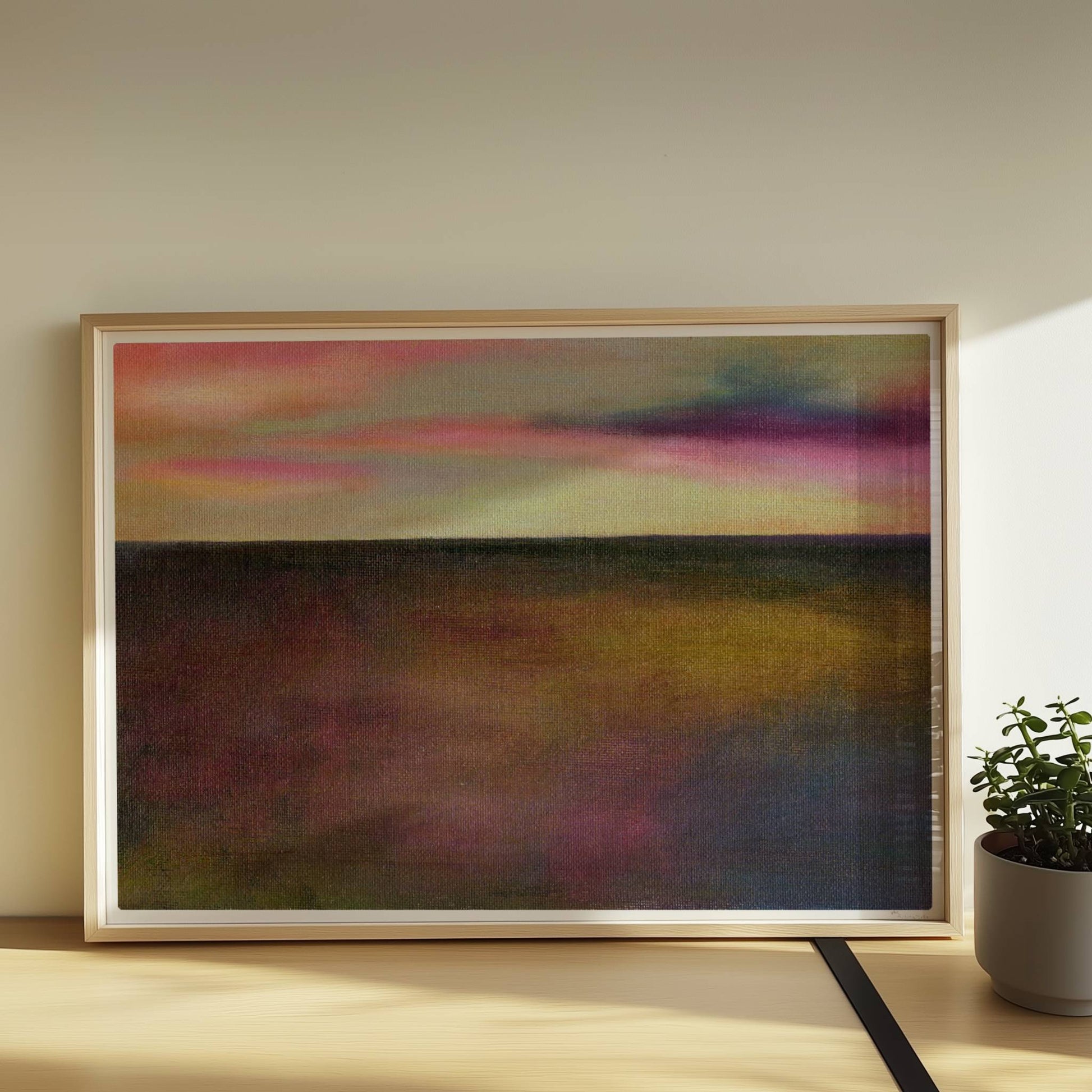 Einzelner goldener Tropfen vor farbigem Wolkenhimmel, surreal.. Rahmen natur 70x50
