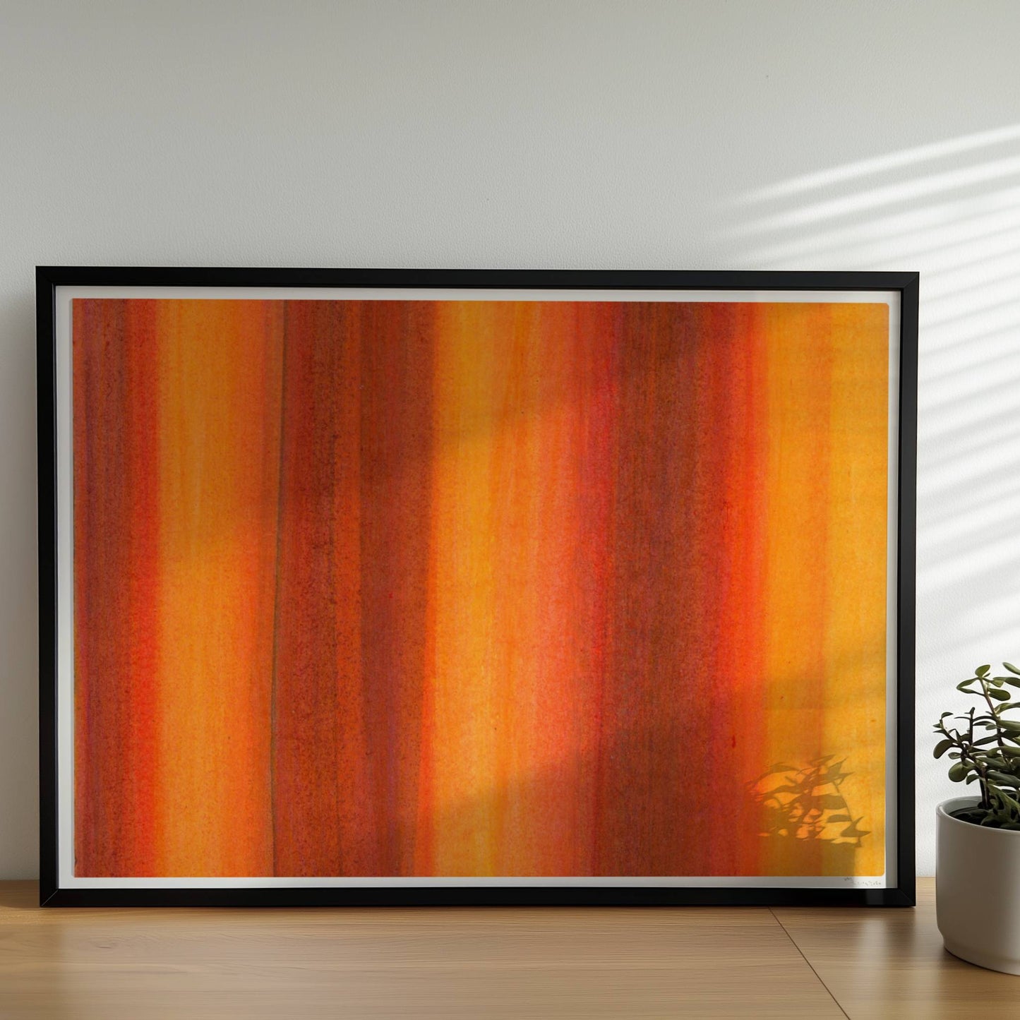 Vertikale Streifen in leuchtendem Orange, Rot und Gelb erzeugen eine abstrakte Wandwirkung mit Wärme und Energie.. Rahmen schwarz 70x50