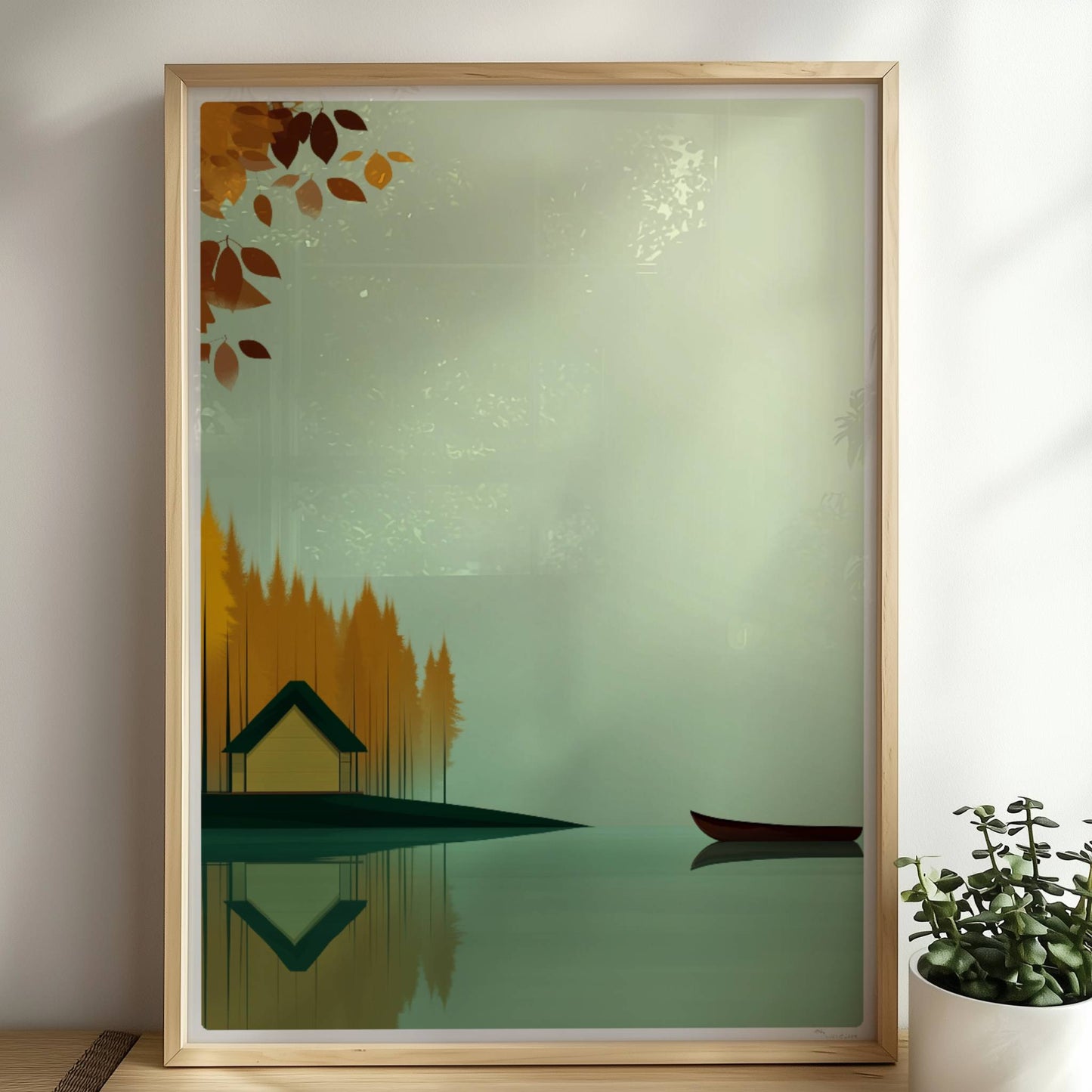 Gelbes Häuschen am See mit grünem Dach, umgeben von herbstlichen Bäumen und einem ruhigen Kanu auf spiegelndem Wasser.. Rahmen natur 50x70